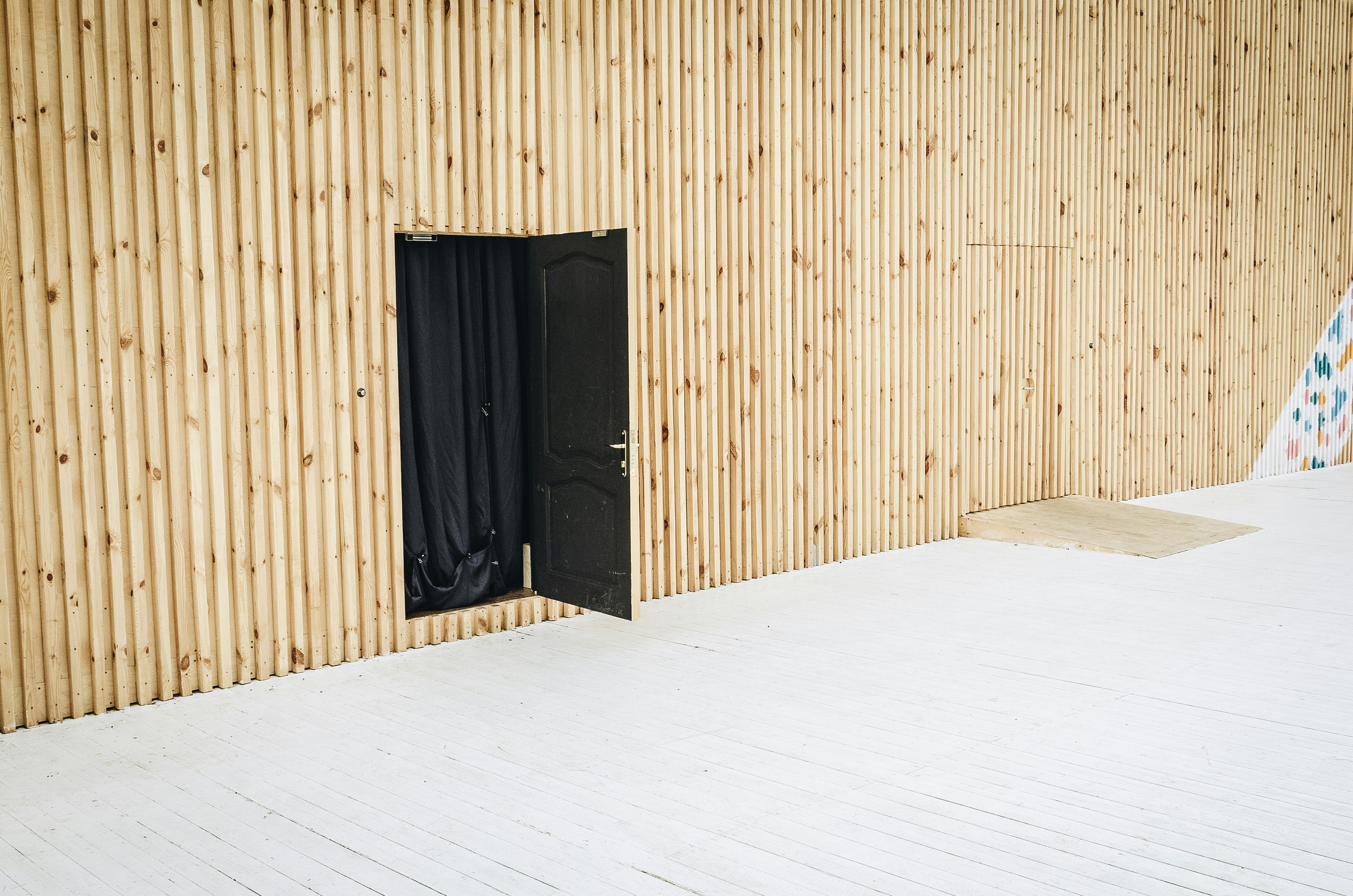 Slat wall concealing doors
